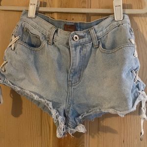 POL, Light wash denim shorts with lace up sides. Size Small
